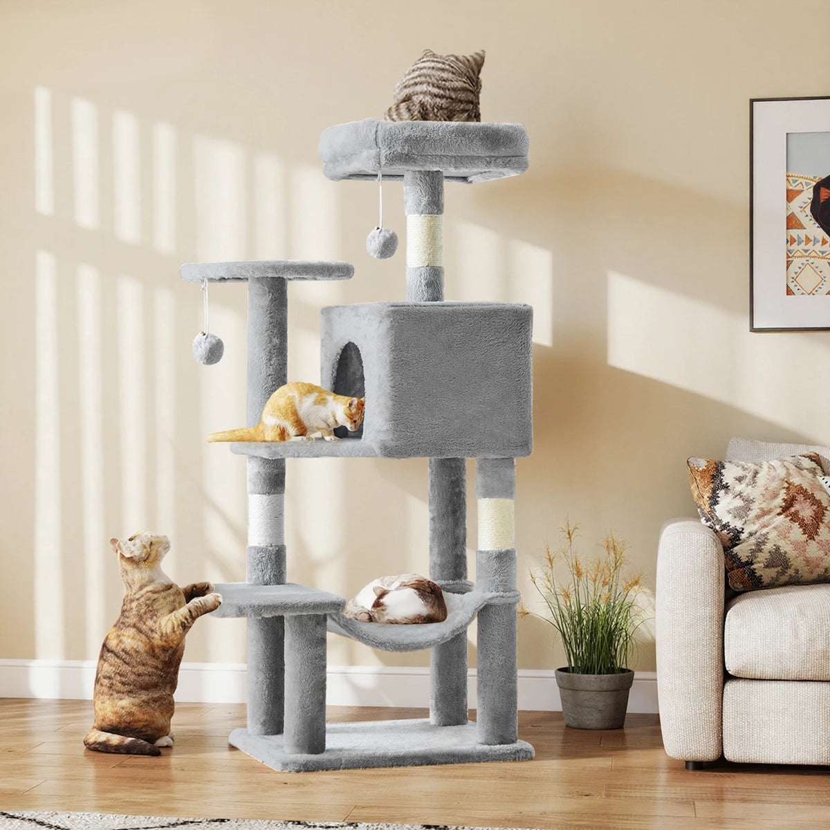 44" Tall Cat Tree – three cats using gray multi-level cat tree with condo, hammock, sisal scratching posts and hanging toys in bright living room